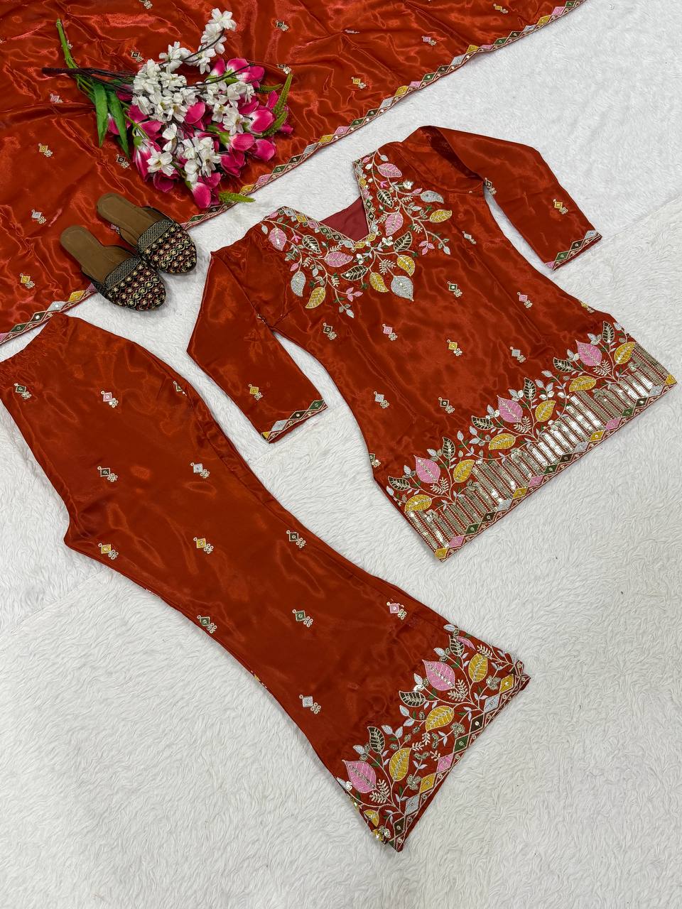 Elegant Rust Orange Silk Kurta and Flared Palazzo Set Adorned with Intricate Multicolored Botanical Embroidery and Mirror Work